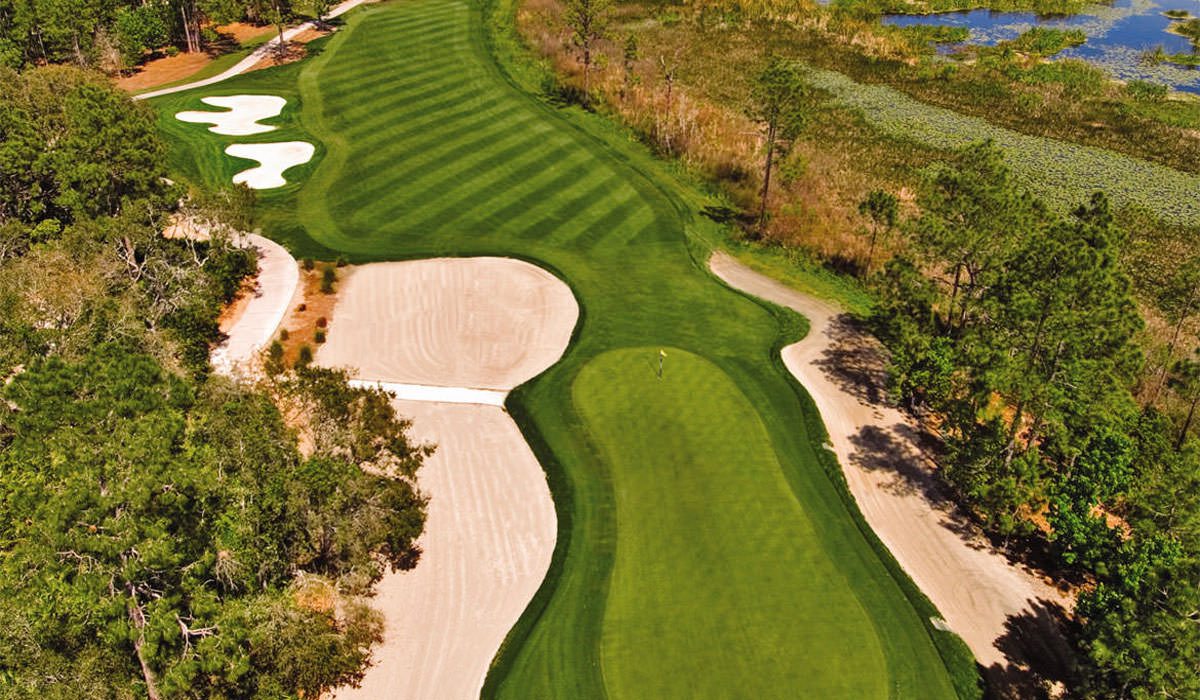 Aerial view of a ChampionsGate golf hole with bright bunkers and wetland scenery