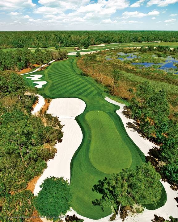 Wide aerial view across a ChampionsGate fairway, green, bunkers, and surrounding Florida landscape
